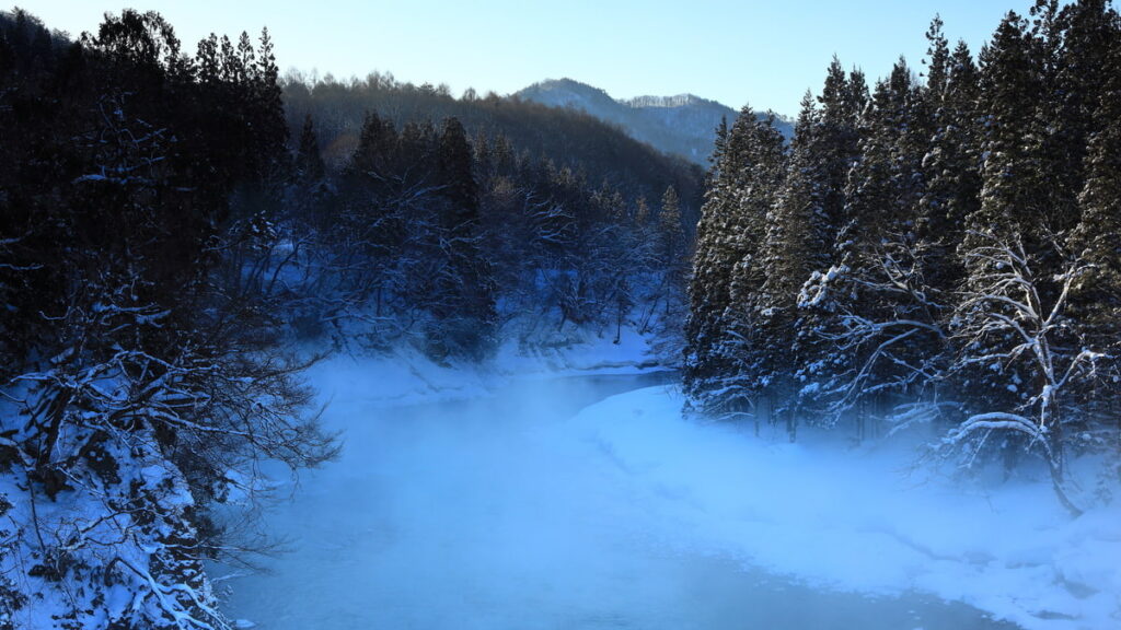 大寒のイメージ。冬の岩手県、雪が積もる山間を流れる和賀川